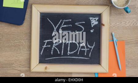 Yes! friday written on a chalkboard at the office Stock Photo