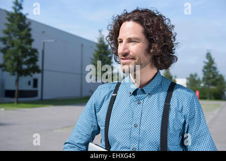 Close up portrait young long haired man braces Stock Photo