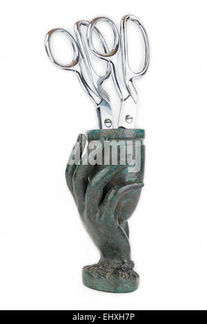 Cast Metal Hand Vase with Two Pairs of Tailors Scissors. Stock Photo