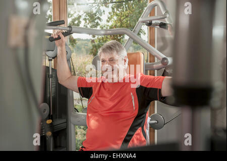 Senior man fitness studio weight training Stock Photo
