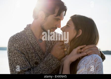 Young couple romantic sunset embracing Stock Photo