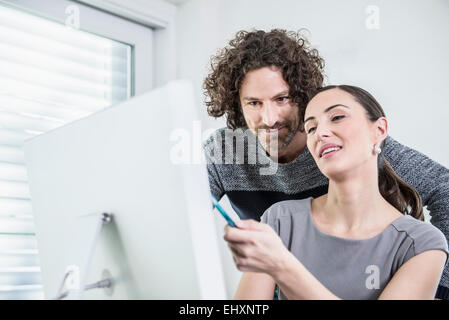 Two business executives working together on a project, Munich, Bavaria, Germany Stock Photo