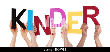 Many Caucasian People And Hands Holding Colorful  Letters Or Characters Building The Isolated German Word Kinder Which Means Kid Stock Photo