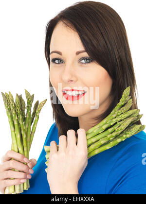 Attractive Young Woman Holding Fresh Asparagus Stock Photo