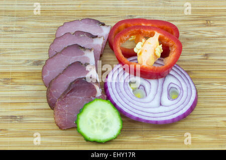 Tasty Ham in slices and three vegetables Stock Photo