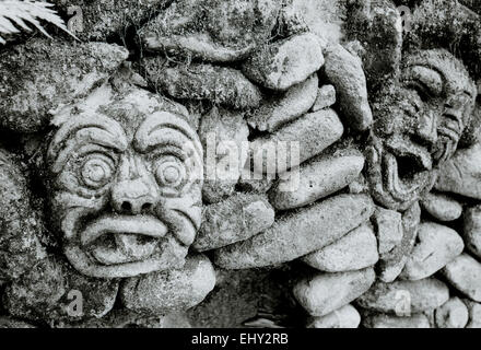 Stone wall sculpture Ubud in Bali in Indonesia in Southeast Asia. Architecture Art Stonework Building Face Gargoyle Humor Humour Funny Travel Stock Photo