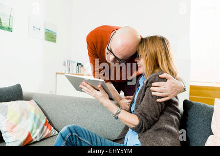 Senior couple using digital tablet at home Stock Photo