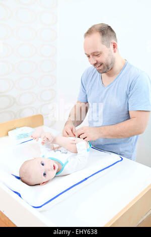 Father changing baby's nappy Stock Photo