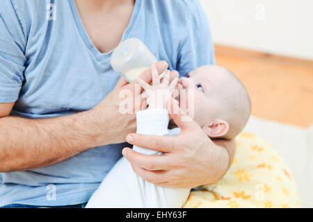 Father feeding baby boy Stock Photo