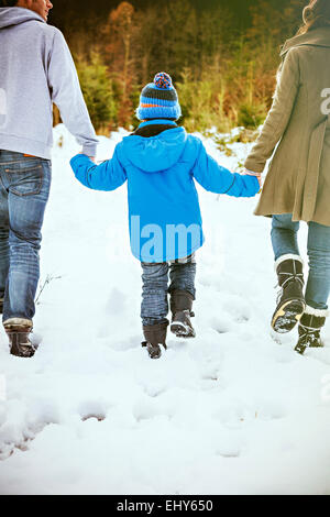 Parents and son searching for the perfect Christmas tree Stock Photo