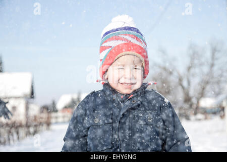 Boy with bobble hat in snow Stock Photo