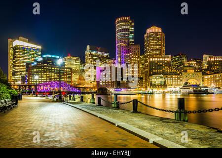 The Boston skyline and Fort Point Channel at night from Fan Pier Park, Boston, Massachusetts. Stock Photo