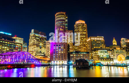 The Boston skyline and Fort Point Channel at night from Fan Pier Park, Boston, Massachusetts. Stock Photo