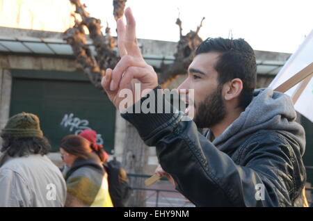 Athens, Greece. 18th Mar, 2015. A demonstrator makes the victory sign.Kurdish immigrants that live in Greece organised a demonstration outside the office of E.U. in Athens in support of the struggle of their people against ISIS militants. Credit:  George Panagakis/Pacific Press/Alamy Live News Stock Photo