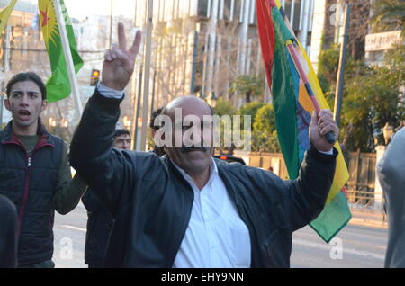 Athens, Greece. 18th Mar, 2015. A demonstrator makes the victory sign.Kurdish immigrants that live in Greece organised a demonstration outside the office of E.U. in Athens in support of the struggle of their people against ISIS militants. Credit:  George Panagakis/Pacific Press/Alamy Live News Stock Photo