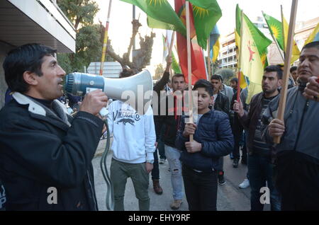 Athens, Greece. 18th Mar, 2015. A demonstrator uses a megaphone to shout slogans. Kurdish immigrants that live in Greece organised a demonstration outside the office of E.U. in Athens in support of the struggle of their people against ISIS militants. Credit:  George Panagakis/Pacific Press/Alamy Live News Stock Photo