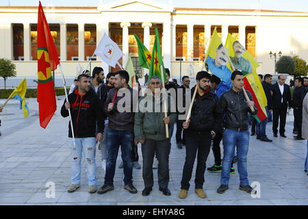 Athens, Greece. 18th Mar, 2015. Kurdish protester have assembled, carrying Kurdish flags. The poster reads 'Stop the killing Jihadists'. Kurdish people in Athens marched to the EU offices in Athens, protesting in support of the Kurdish people in Syria, and called for the Turkish president Erdo?an to support them against the Islamic State. © Michael Debets/Pacific Press/Alamy Live News Stock Photo