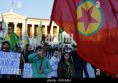 Athens, Greece. 18th Mar, 2015. A Kurdish protester holds a Kurdistan Workers' Party (PKK) flag outside the University of Athens building. Kurdish people in Athens marched to the EU offices in Athens, protesting in support of the Kurdish people in Syria, and called for the Turkish president Erdo?an to support them against the Islamic State. © Michael Debets/Pacific Press/Alamy Live News Stock Photo