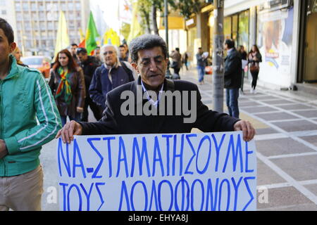 Athens, Greece. 18th Mar, 2015. A Kurdish protester holds a poster that reads 'Stop the murdering Jihadists'. Kurdish people in Athens marched to the EU offices in Athens, protesting in support of the Kurdish people in Syria, and called for the Turkish president Erdo?an to support them against the Islamic State. © Michael Debets/Pacific Press/Alamy Live News Stock Photo