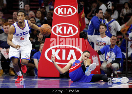 Philadelphia, Pennsylvania, USA. 18th Mar, 2015. Philadelphia 76ers guard Ish Smith (5) bring sup the ball with Detroit Pistons forward Tayshaun Prince (22) laying on the court during the NBA game between the Detroit Pistons and the Philadelphia 76ers at the Wells Fargo Center in Philadelphia, Pennsylvania. Credit:  csm/Alamy Live News Stock Photo