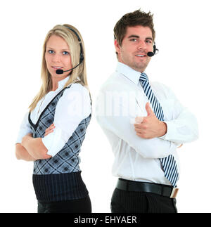 Young employee working with a headset and accompanied by his team Stock Photo