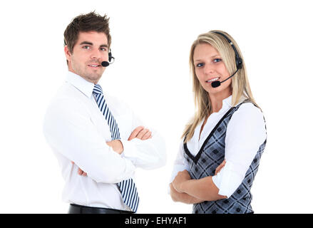 Young employee working with a headset and accompanied by his team Stock Photo