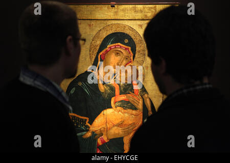 Prague, Czech Republic. 18th March 2015. Visitors examine the Cretan icon of Mother of God Glykophilousa from the second half of the 15th century to the first half of the 16th century during the opening of the exhibition Byzantine Tradition across the Centuries in Prague, Czech Republic. The exhibition presenting an excellent selection of Greek orthodox icons from the collections of the Kondakov Archaeological Institute (Prague) and the Museum of the Russian Icon (Moscow) runs till May 13, 2015, in the Strahov Picture Gallery. Stock Photo