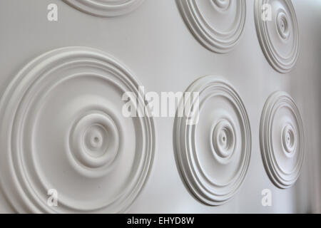 Round white stucco on the wall Stock Photo