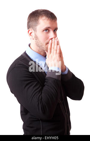 A young man with folded hands near face Stock Photo