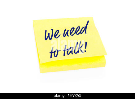 Yellow sticky note on block with text We Need To Talk Stock Photo