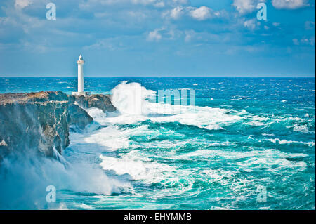 Waves crashing on rocks by a lighthouse in the wake of a typhoon, Okinawa, Japan Stock Photo