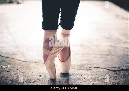 Legs of a ballet dancer standing en pointe Stock Photo
