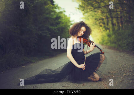 Sad young woman playing the violin Stock Photo