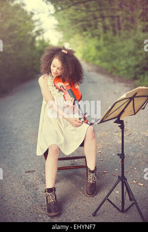 Young woman playing the violin Stock Photo