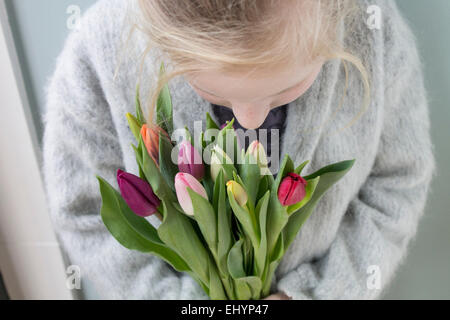 Girl holding a bunch of tulips Stock Photo