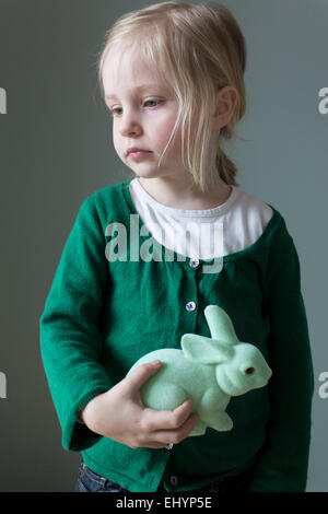 Portrait of a Girl holding a cuddly rabbit toy Stock Photo