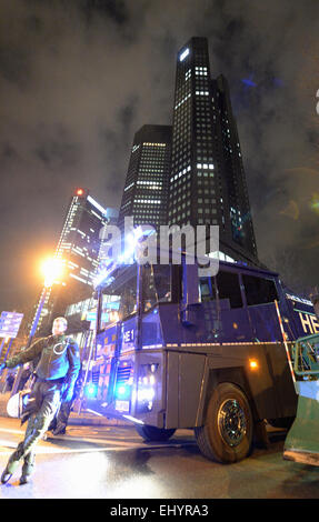 Frankfurt, Germany. 18th Mar, 2015. Riot police and water connon stand position in front of the office highrises after the Deutsche Bank in Frankfurt, Germany, 18 March 2015. The new headquarters of the European Central Bank (ECB) was opened in Frankfurt amid severe protests. Credit:  dpa picture alliance/Alamy Live News Stock Photo