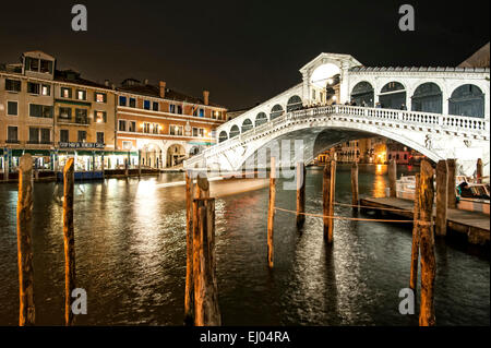 Pier with boat on the Grand Canal at the Rialto Bridge at night. Stock Photo