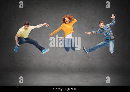 group of smiling teenagers jumping in air Stock Photo