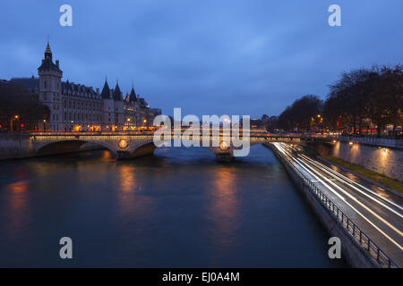 View of the Seine River by twilight from Pont Notre Dame, with the Conciergerie in the background. Paris, Ile de France, France. Stock Photo