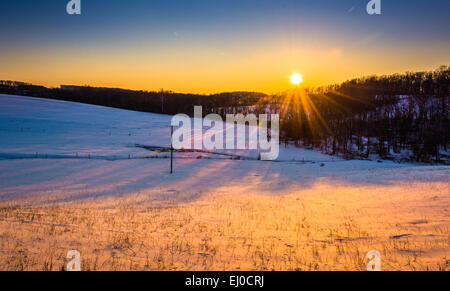Sunset over farm fields in rural York County, Pennsylvania. Stock Photo