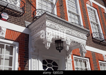 London, Westminster   A typical wooden canopy or portico above one of the early 18th century doors in Queen Anne's Gate Stock Photo