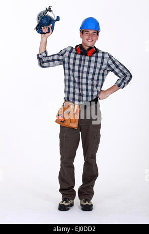 Construction worker using circular saw Stock Photo