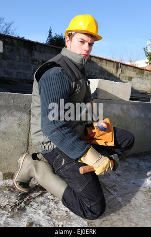 Mason working on building foundations Stock Photo