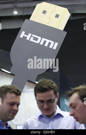 Hanover, Germany. 16th Mar, 2015. Visitors stand at the fair stand of a manufacturer of HDMI cables at the computer fair CeBIT in Hanover, Germany, 16 March 2015. Photo: Friso Gentsch/dpa/Alamy Live News Stock Photo