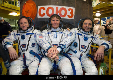 International Space Station Expedition 43 crew members NASA Astronaut Scott Kelly, left, and Russian Cosmonauts Gennady Padalka, center, and Mikhail Kornienko of the Russian Federal Space Agency pose during their Soyuz TMA-16M spacecraft fit check at the Baikonur Cosmodrome March 15, 2015 in Kazakhstan.  The trio are preparing for launch to the International Space Station in their Soyuz TMA-16M spacecraft scheduled for March 28. Stock Photo