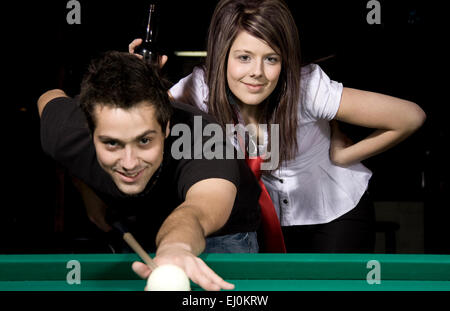 Man playing snooker in the dark club. Stock Photo