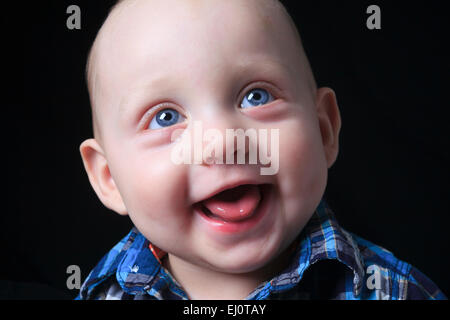 beautiful little boy portrait on dark background Stock Photo