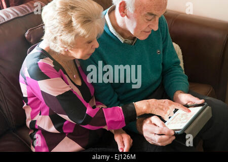 Horizontal portrait of an elderly couple using an ipad together. Stock Photo