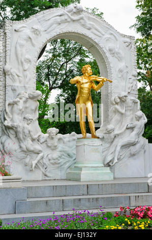 A golden coloured statue of Johann Strauss playing a violin, Vienna, Austria. Stock Photo